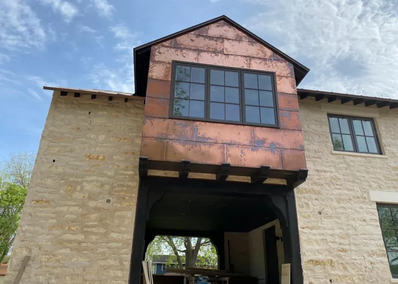 Copper metal panel facade on a stone building for Metal Roof Coating in Simpsonville